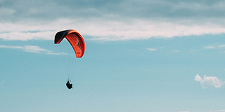 A man paragliding - by George Bakos