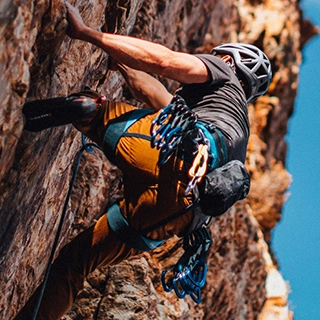 Man climbing on a rock - by Patrick Hendry
