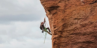 Man climbing on a rock - by Sean Benesh
