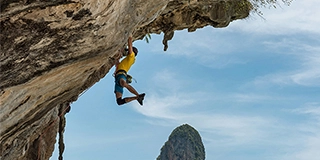 Man climbing on a rock - by hu Chen