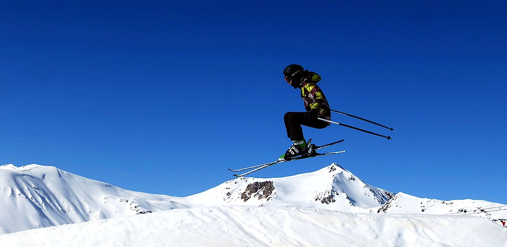 A man flying through the air while riding skis - Josef Pelikan