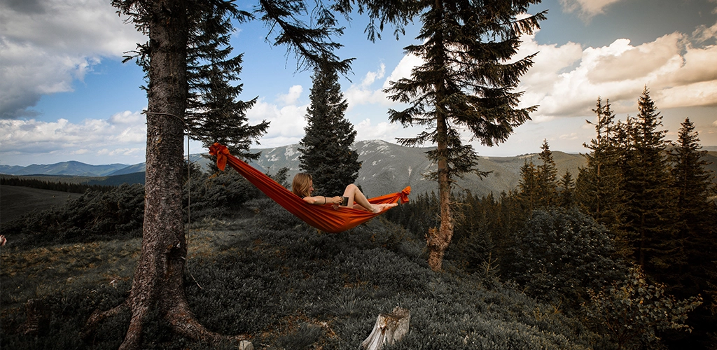 Person lying on red hammock - Max Vertsanov